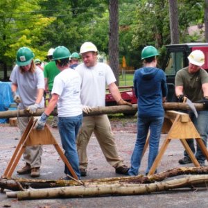 Teaching volunteers how to use a saw