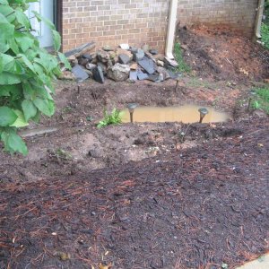 after a night of rain the area dug out for the pond is full of water