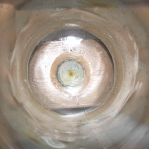 The inside of one of the cut off two liter bottles. It is an airline tube going up with silicone up to the rim of the tube so brine shrimp eggs cant r