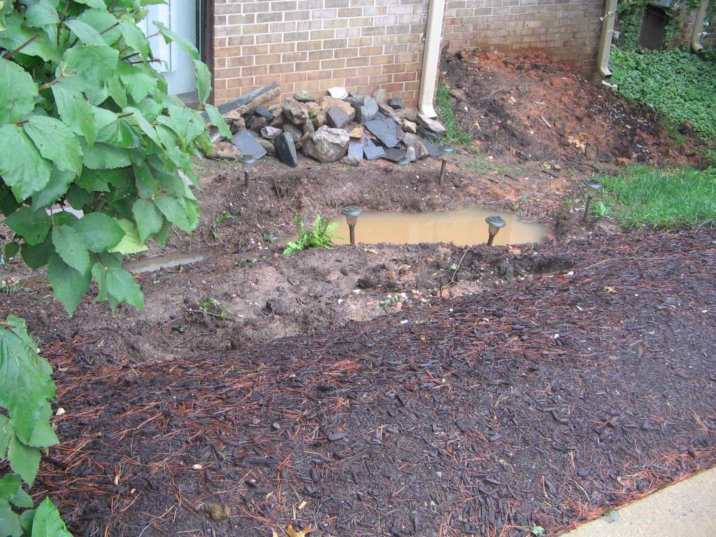 after a night of rain the area dug out for the pond is full of water