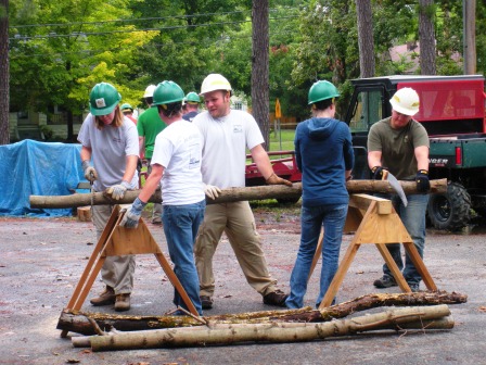 Teaching volunteers how to use a saw